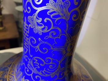 A Chinese powder blue and gilt 'lotus scroll' bottle vase, Kangxi mark, 19/20th C.